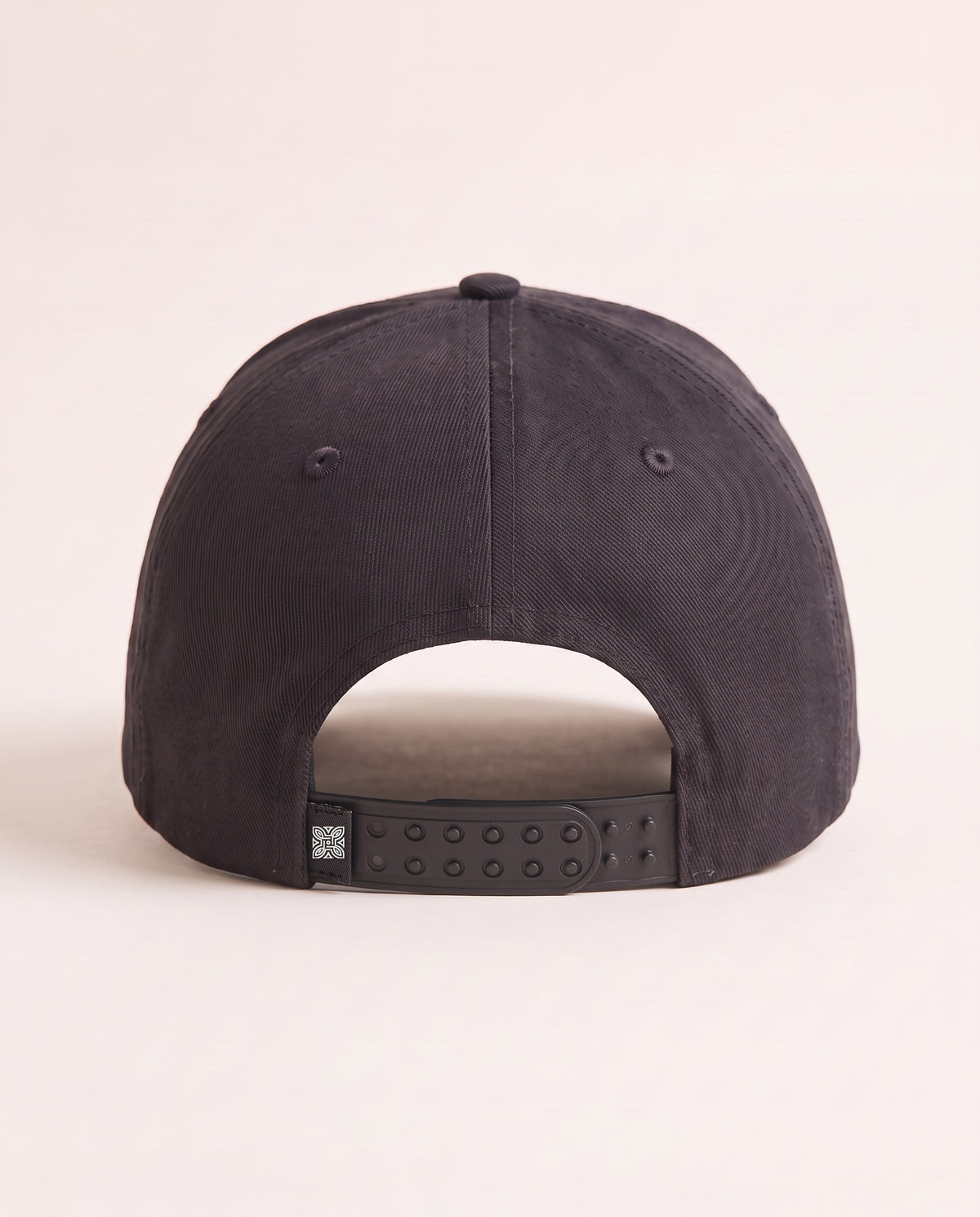 Maison Cap in Ink, back: double-row snapback with embroidered knot tab